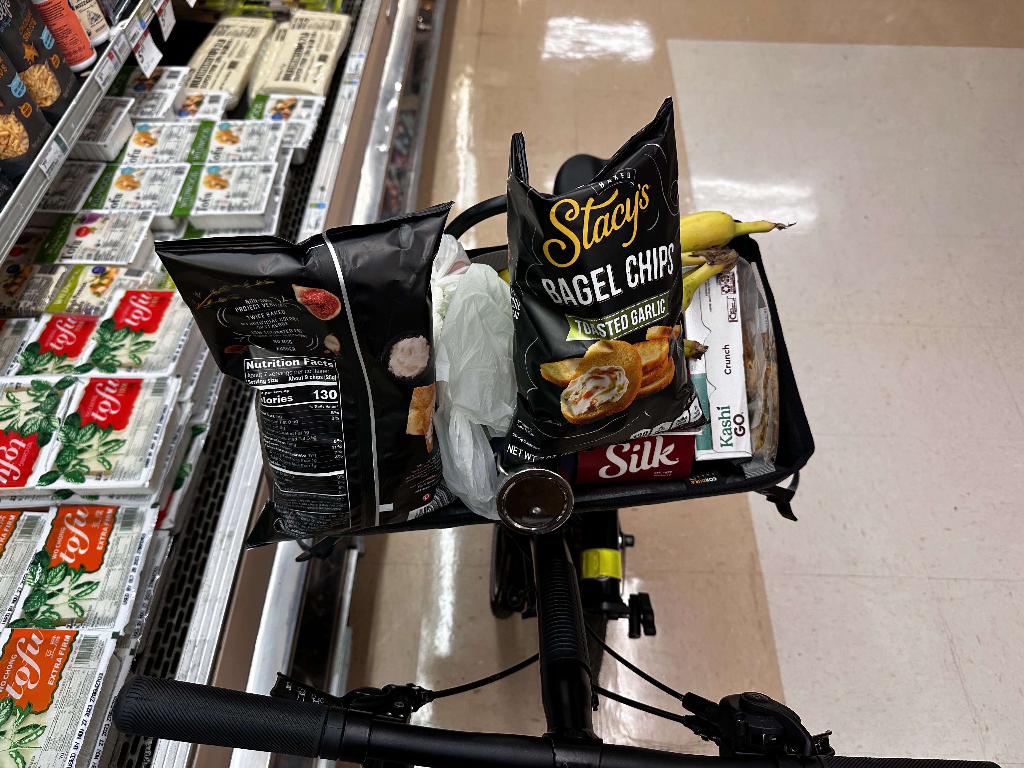 Author showing a basket full of Stacys chips and ironically labelling it as necessary grociers